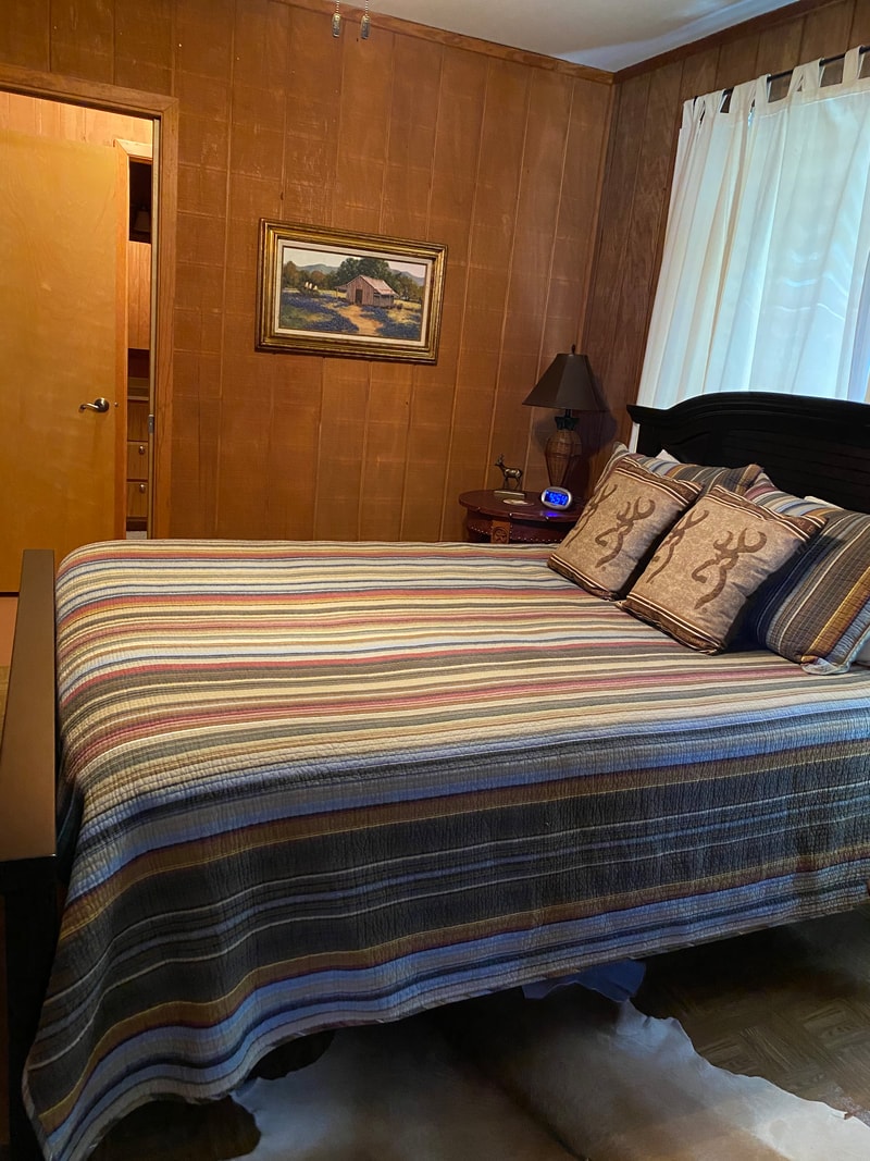 Rustic bedroom with striped bedspread and pillows