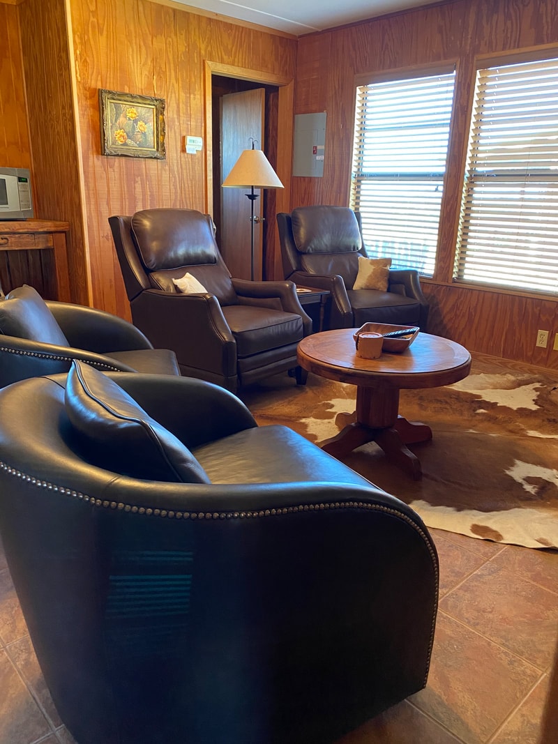Leather chairs around a wooden coffee table