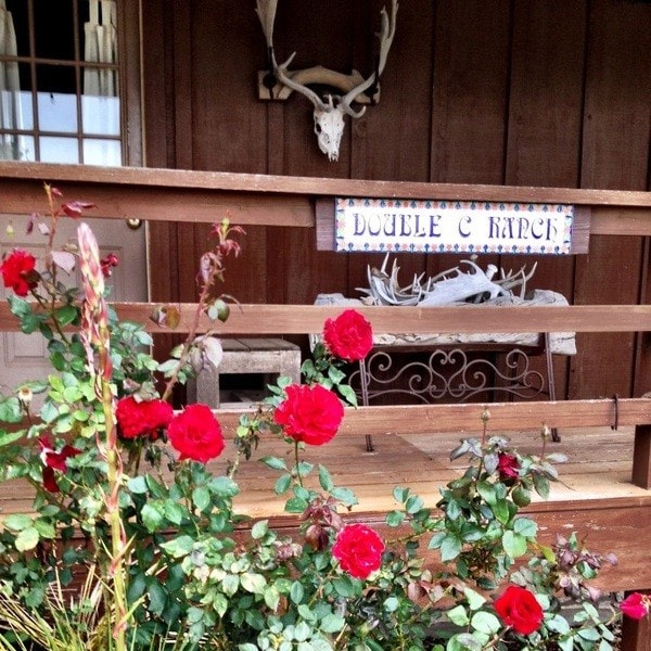 Ranch sign with antlers and red roses