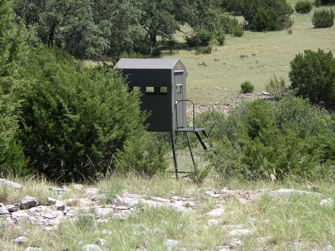Elevated hunting blind in a wooded hillside